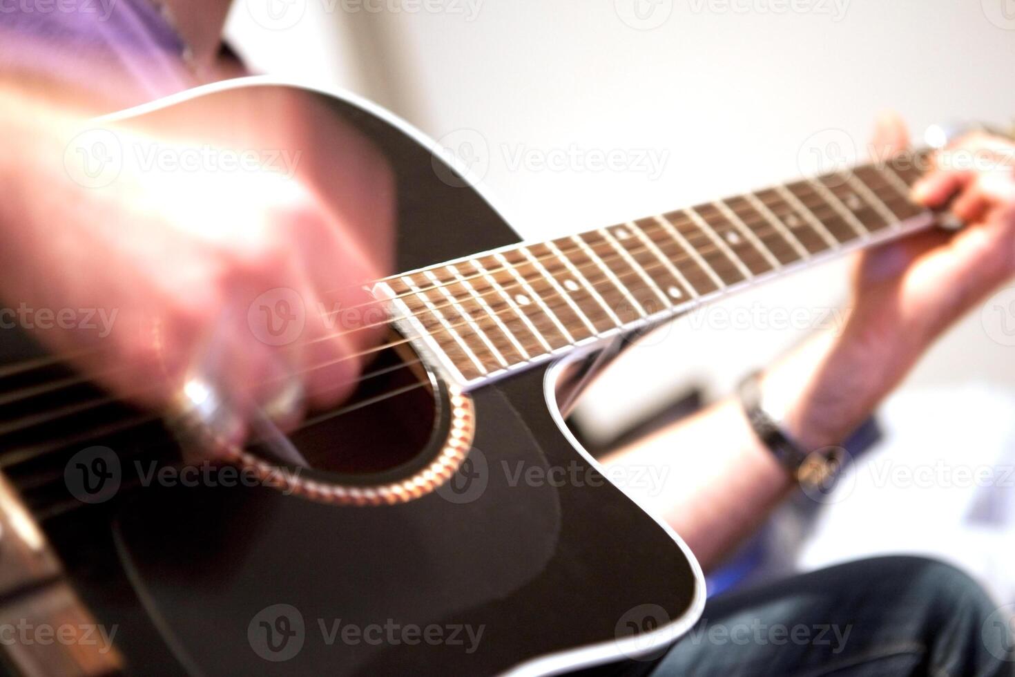 Guitar player.Man playing acoustic guitar photo