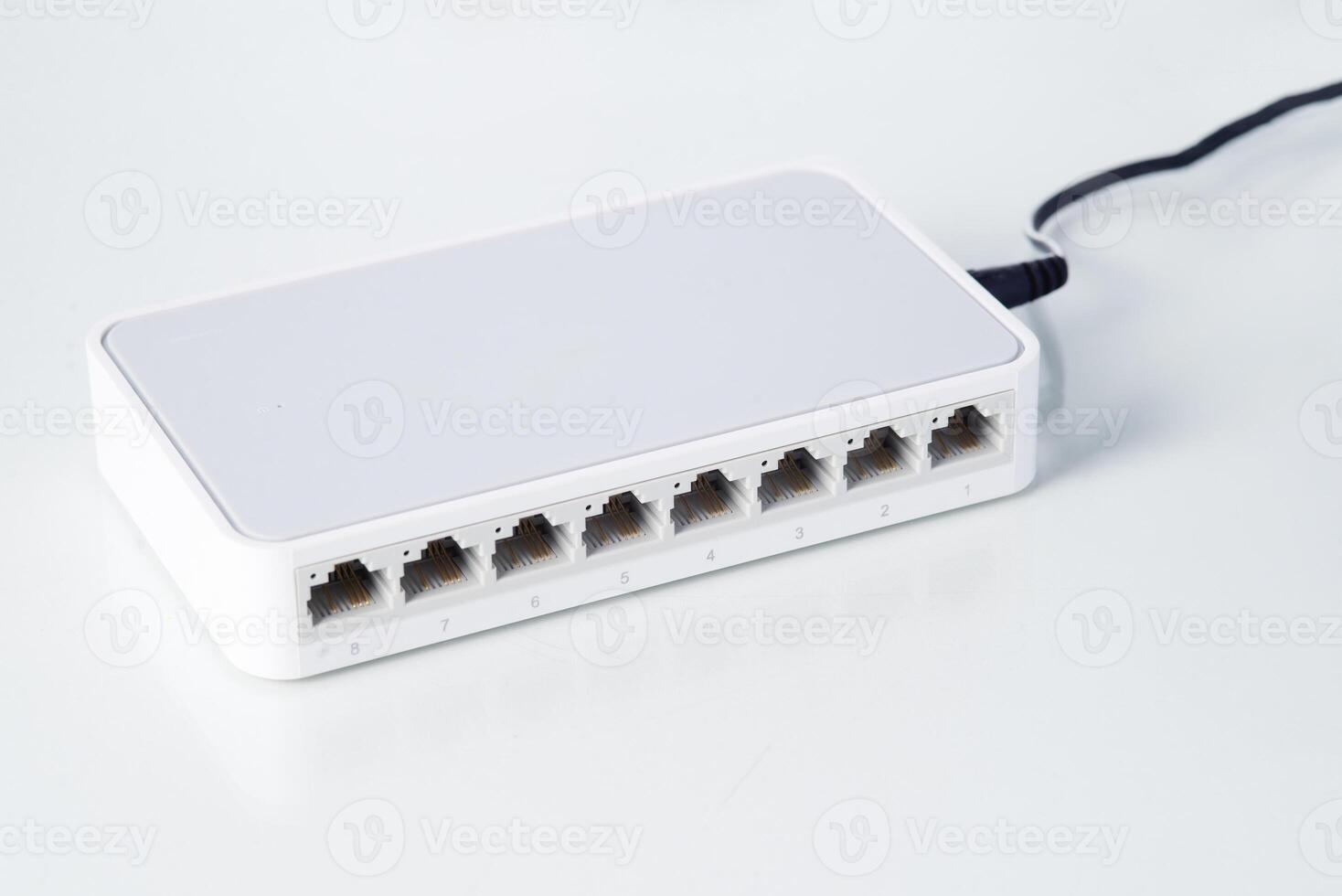 Ethernet network switch with eight ports on a clean background, used for internet connectivity and data distribution. photo