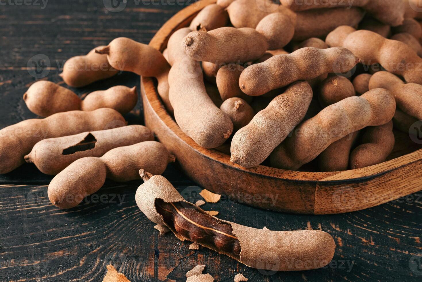Pile of fresh tamarind fruits in shell photo
