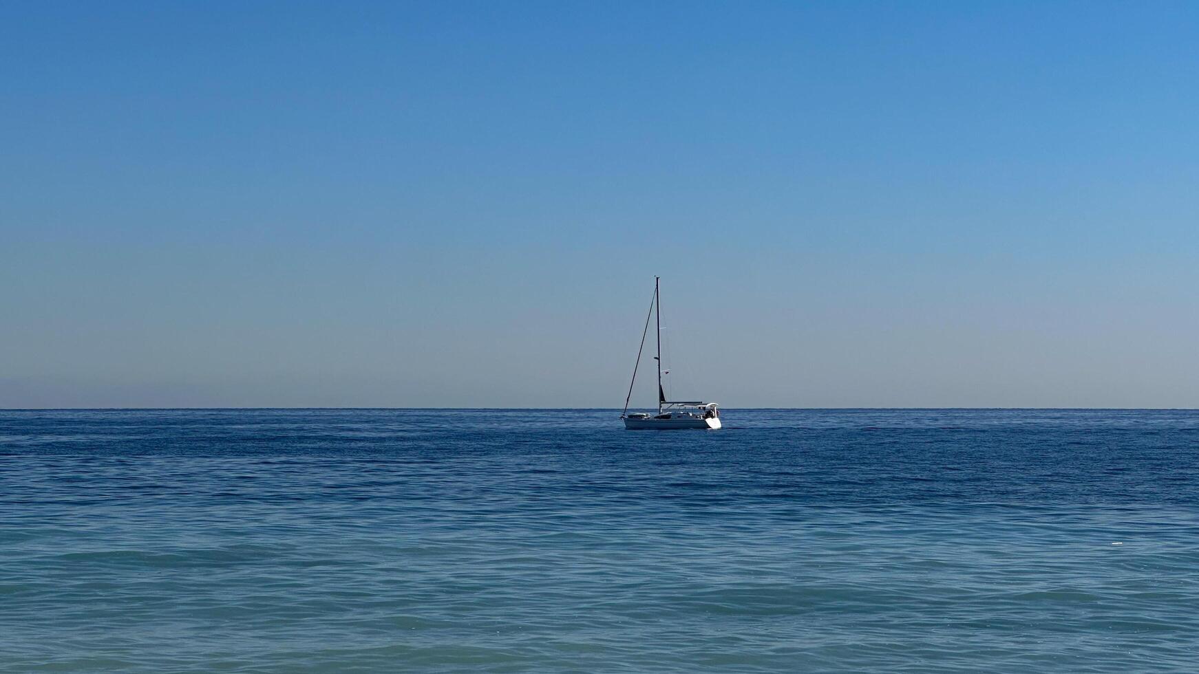 Yacht in the sea on a background of blue sky.Mediterranean Sea, Turkey.. photo