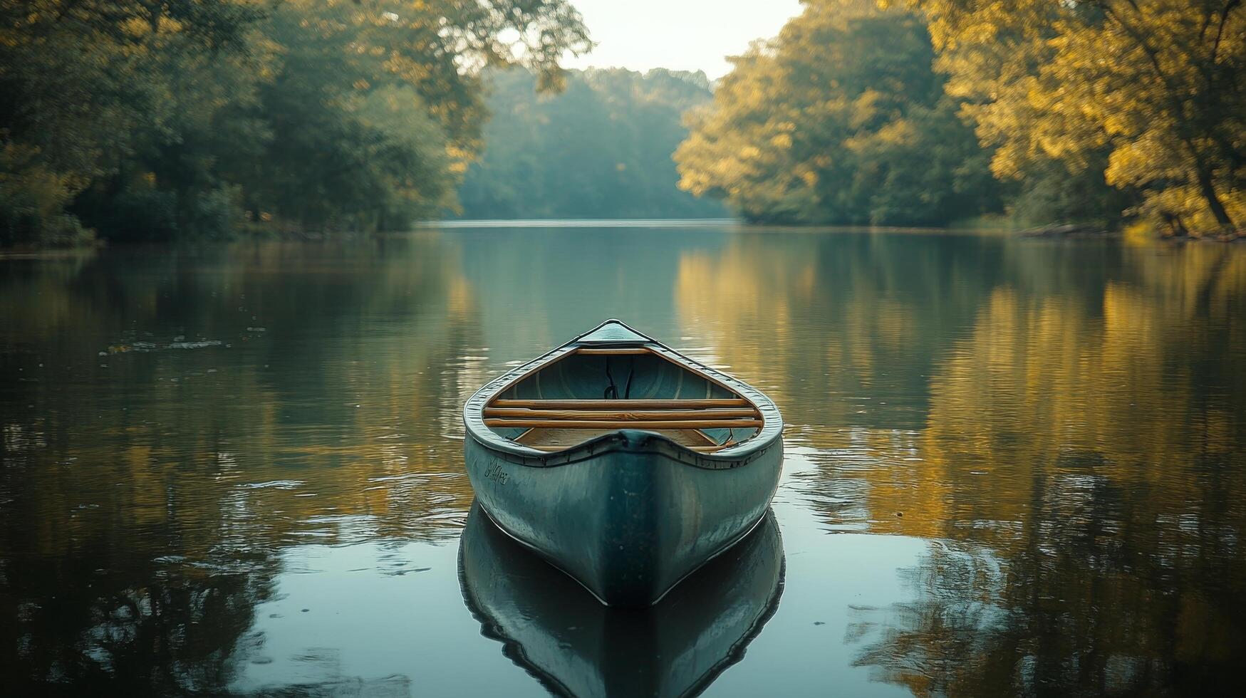 A canoe is floating on the water in the middle of a lake photo