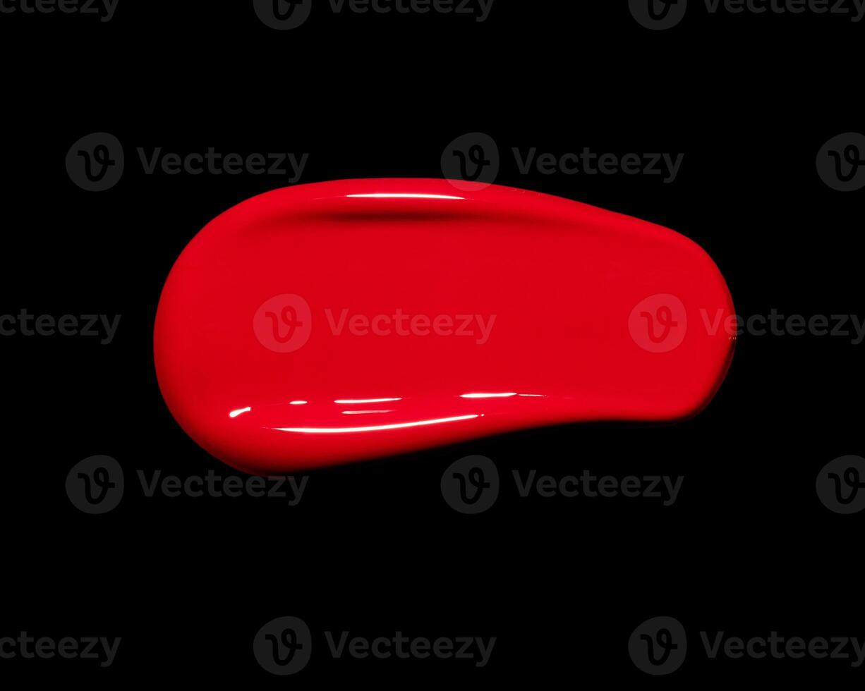 red lipgloss swatch on black background, cosmetic or beauty product texture photo