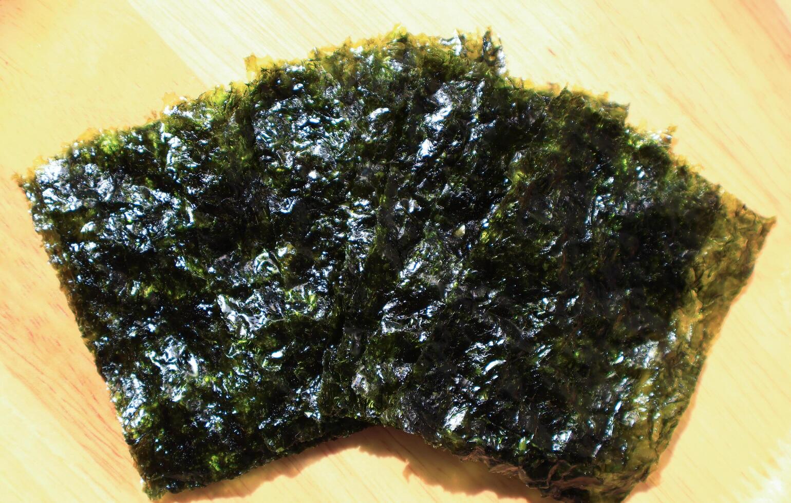 high angle view of roasted seaweed snack on wooden board photo