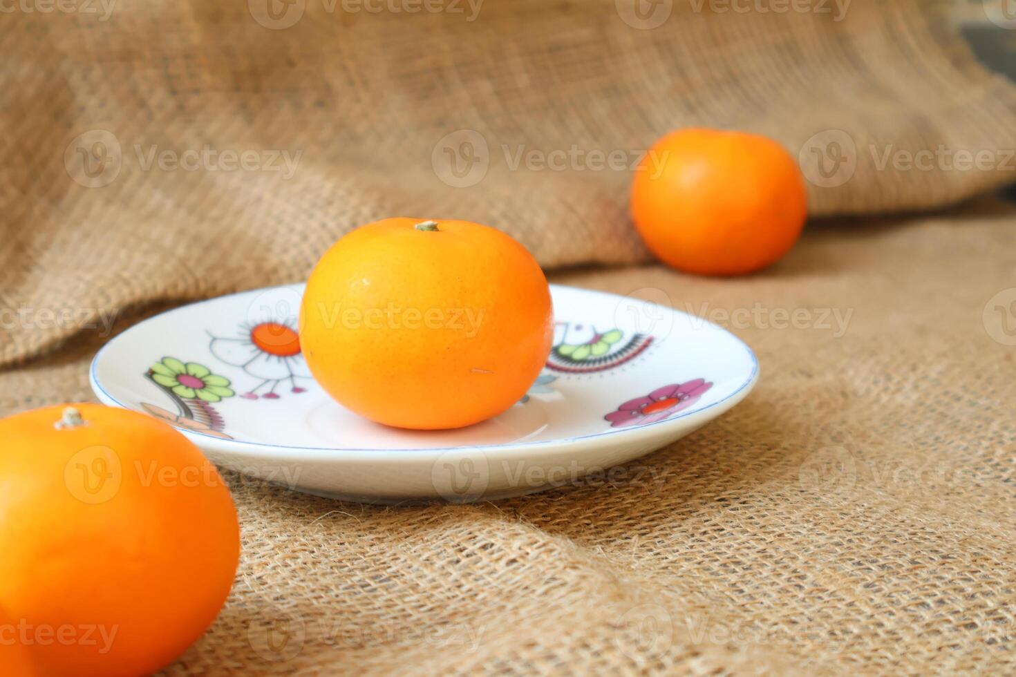 Side view of citrus fruits on a plate. Wogan Orange. with copy space photo