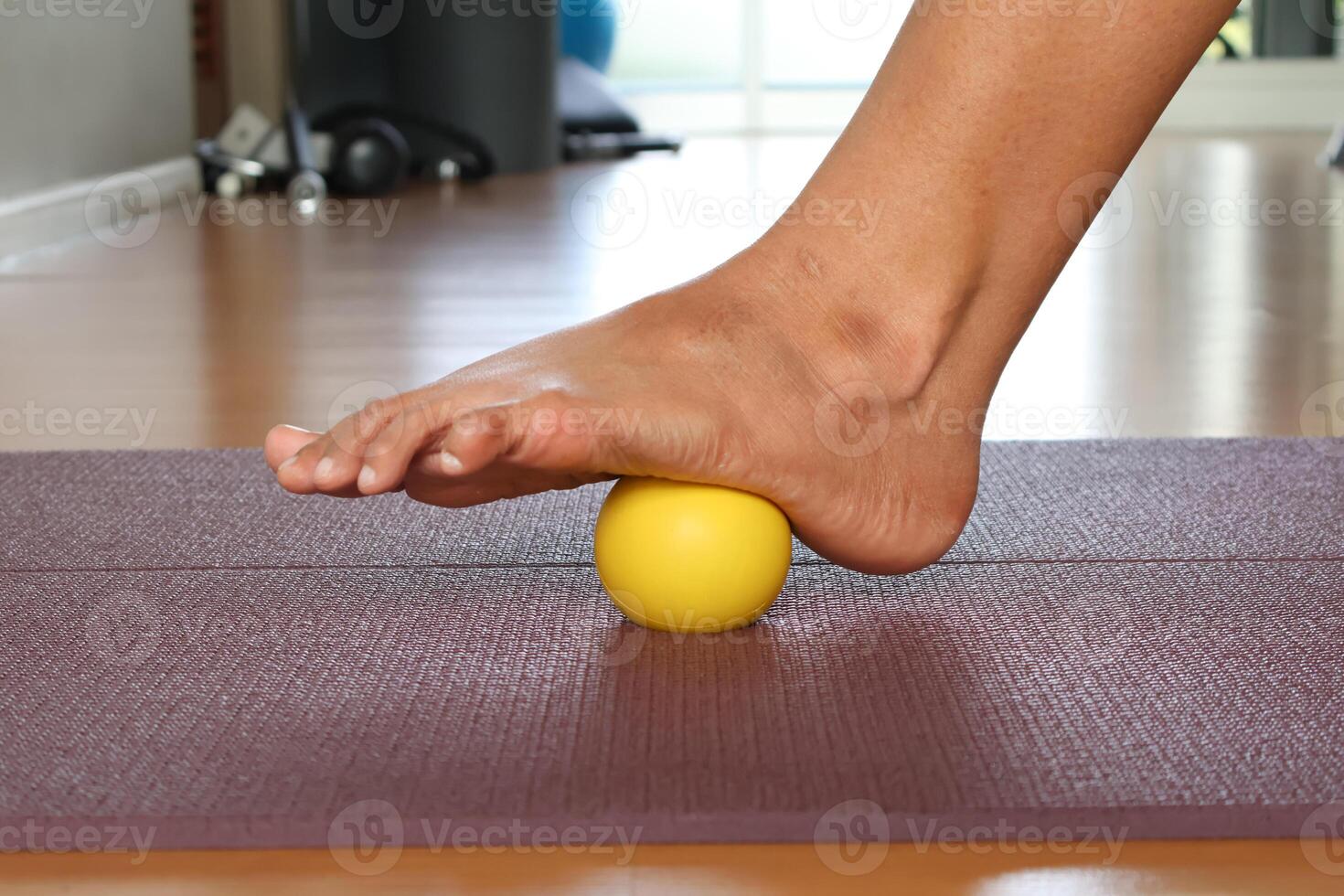 Use a foot massage ball to relieve plantar fascia. photo