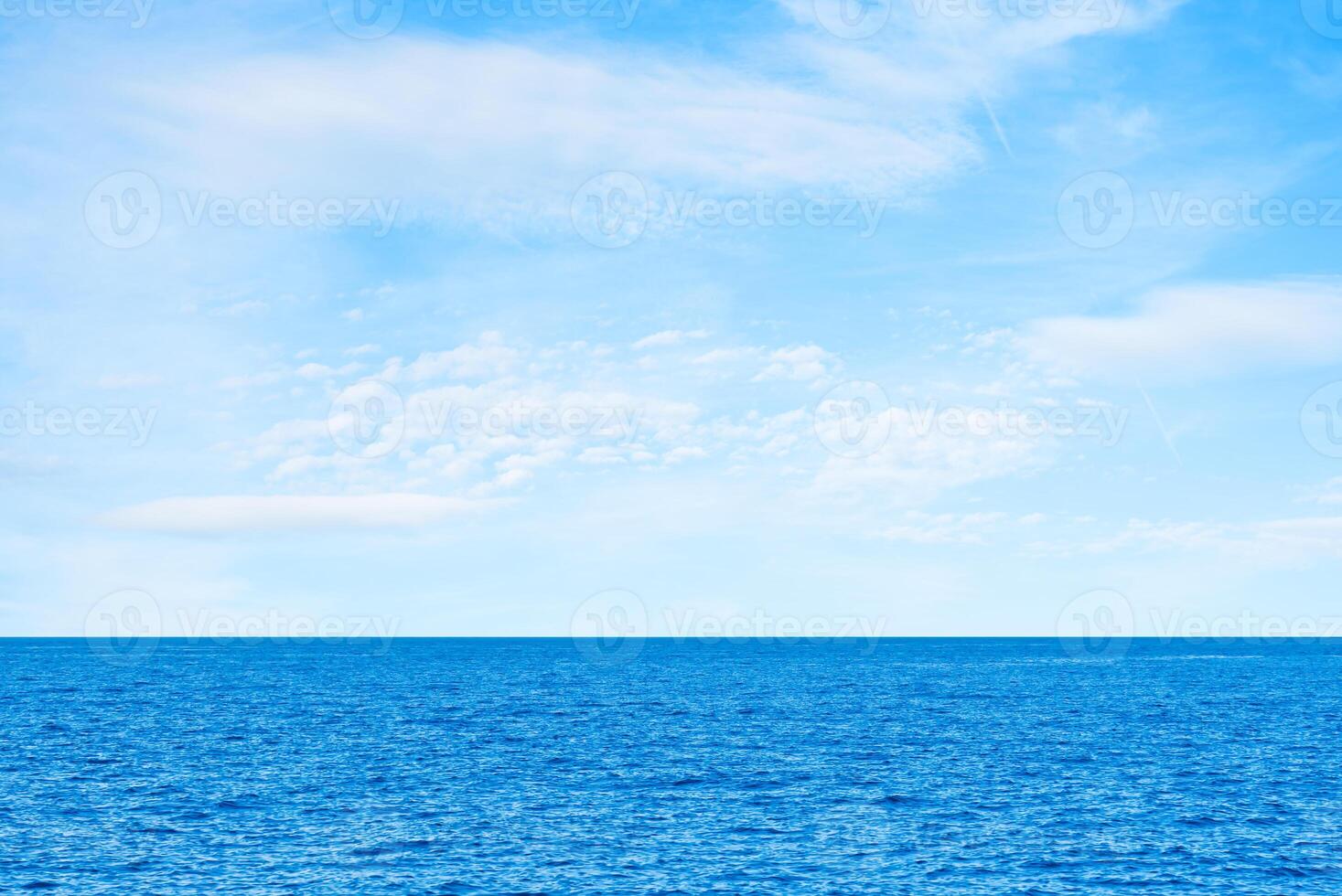 Blue sea and white clouds on sky. Water cloud horizon background. Feeling calm, cool, relaxing. The idea for cold background and copy space on the top. the ocean deep indigo photo