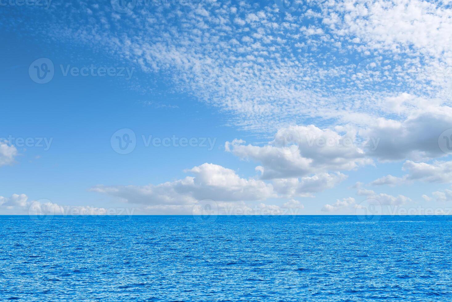 Blue sea and white clouds on sky. Water cloud horizon background. Feeling calm, cool, relaxing. The idea for cold background and copy space on the top. the ocean deep indigo photo