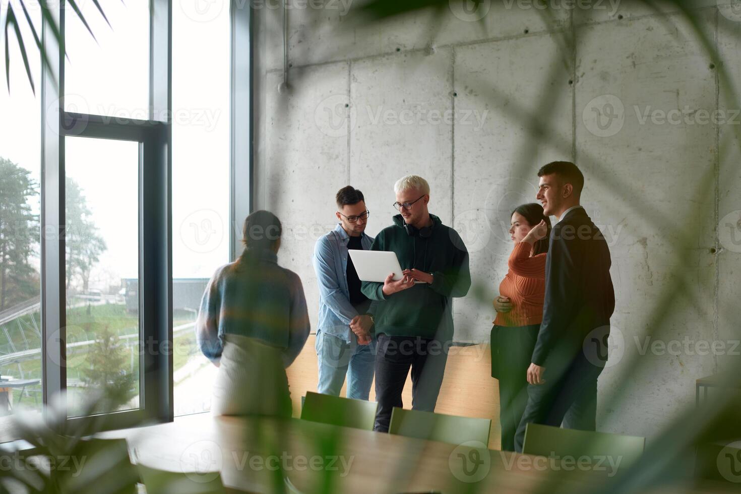 A diverse multiethnic business team engages in a collaborative meeting, discussing strategies and solutions in a modern office setting photo