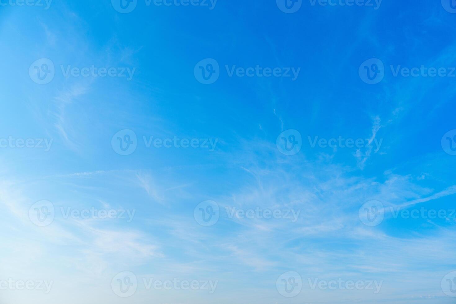 Delicate feathery cirrus clouds drift across the expanse of the sky, creating a serene and tranquil scene. Perfect for backgrounds, weather illustrations, and nature-themed projects. photo