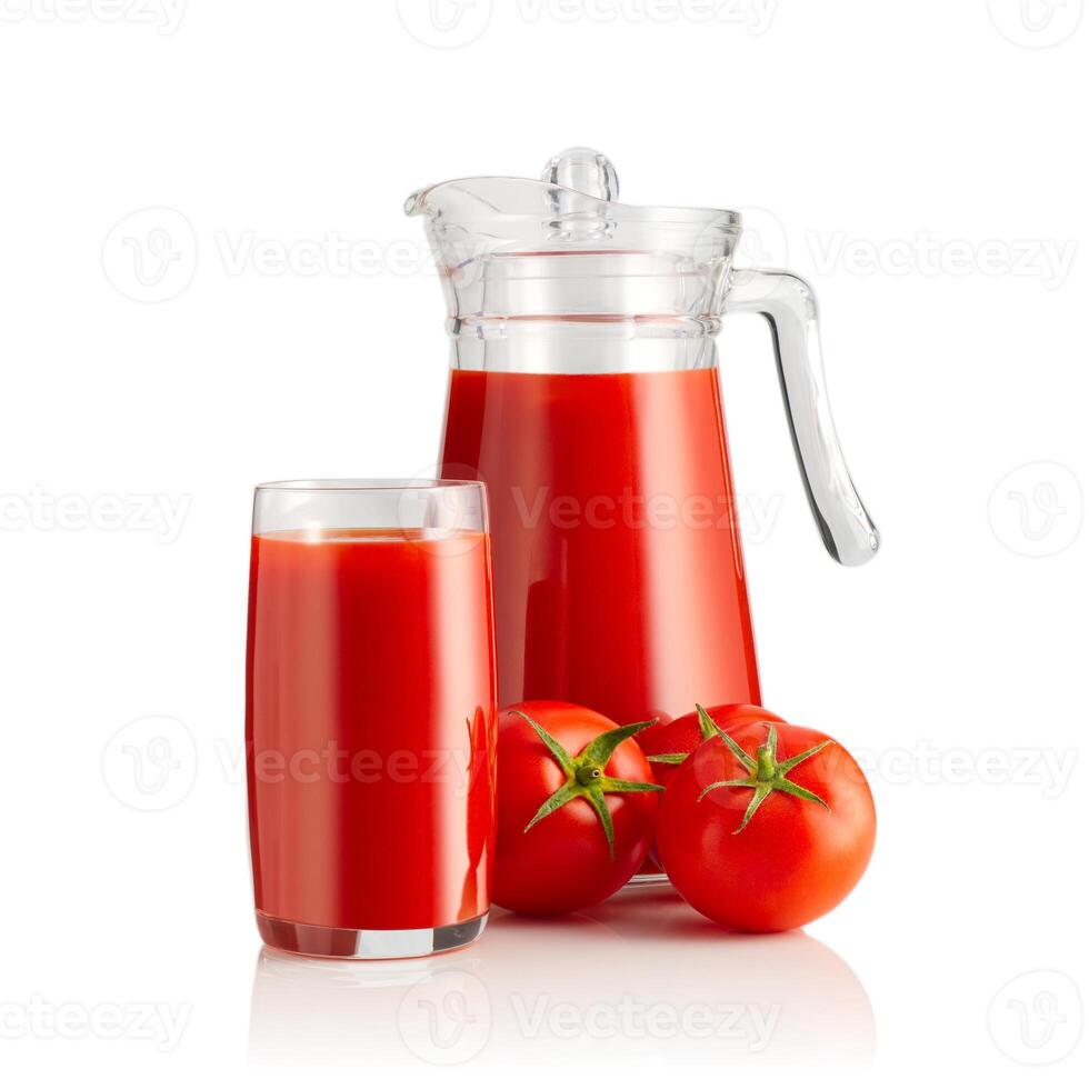 A refreshing glass and jug of freshly squeezed tomato juice, accompanied by two ripe tomatoes, perfect for a healthy snack or meal addition, bursting with flavor and nutrition. photo