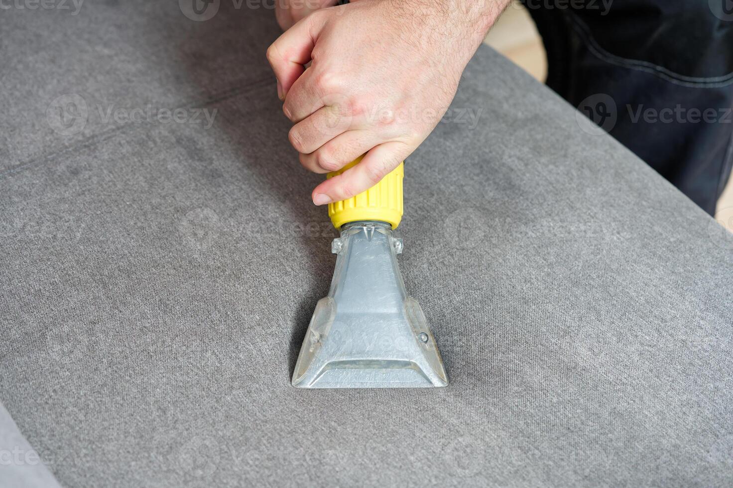 Sofa chemical cleaning with professionally extraction method. Wet textile sofa cleaning. home cleaning service. cleaning sofa with washing suction cleaner closeup. photo