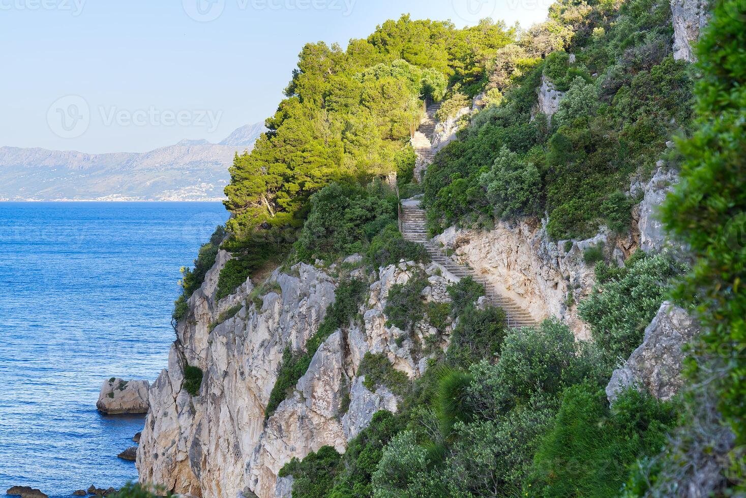 way to small church sanctuary of Blessed Mary of Conception - Gospe od Prizidnice, upright rock, high over sea. Trogir, Croatia photo