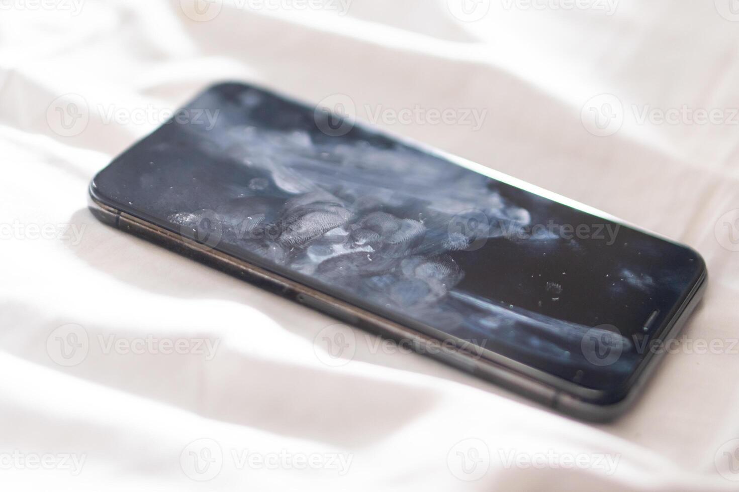 Close-up of a Smudged Smart phone on Soft Surface photo