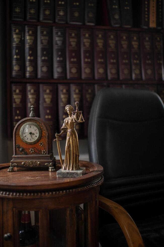 distinguished lawyers office with dark wooden furniture, legal documents neatly arranged, and a striking statue of Themis. The combination of law and symbolism creates a powerful setting photo