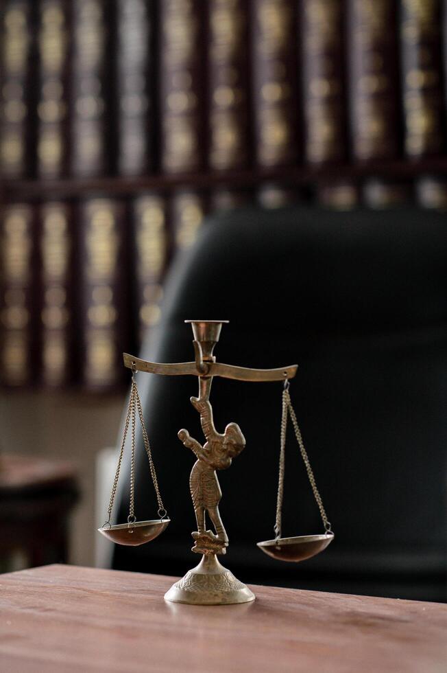 A refined legal workspace with antique wooden furniture, an elegant clock, and a decorative statue of scales, symbolizing fairness and order photo