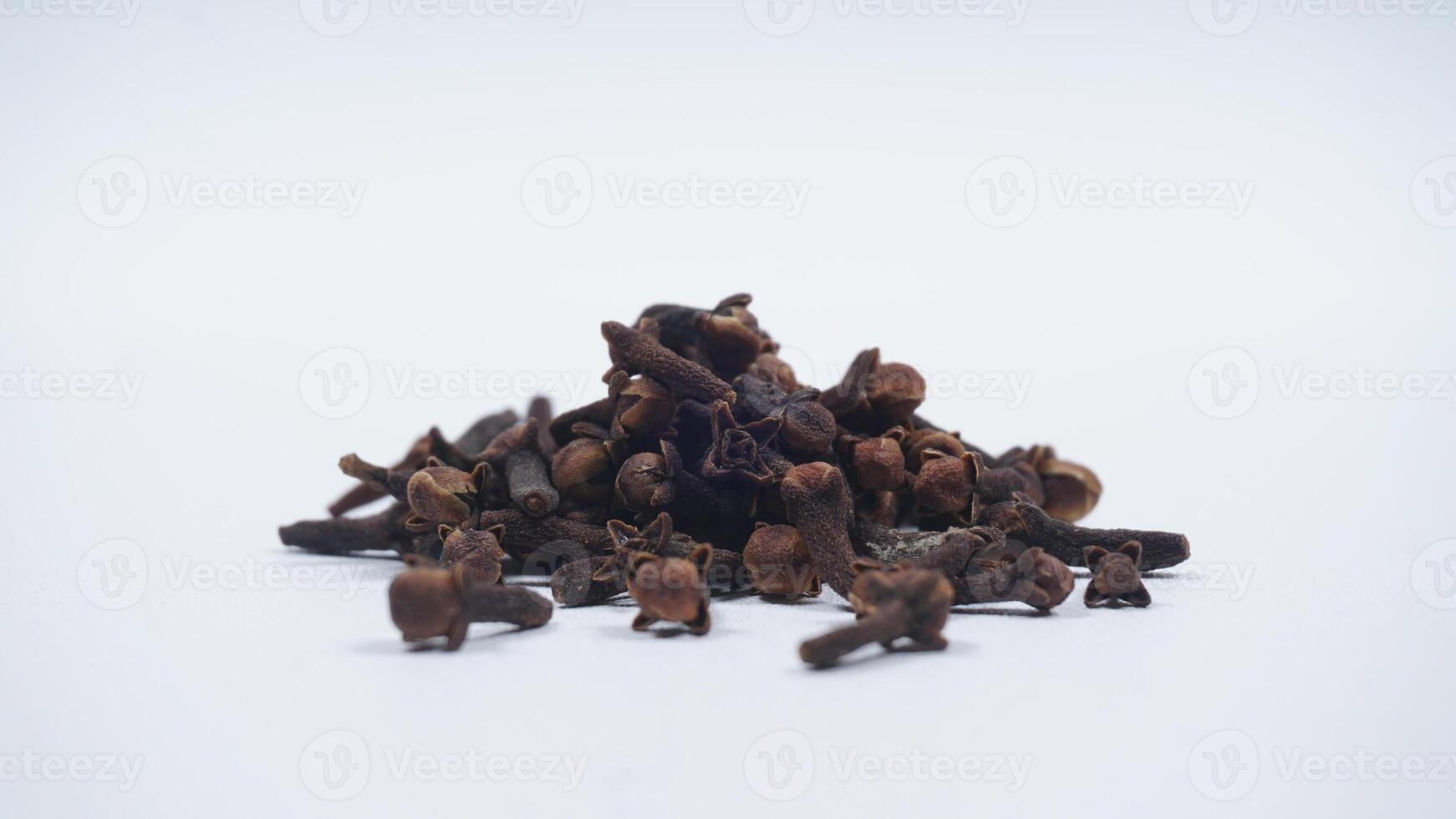 Pile of Dried Cloves Isolated on White Background photo