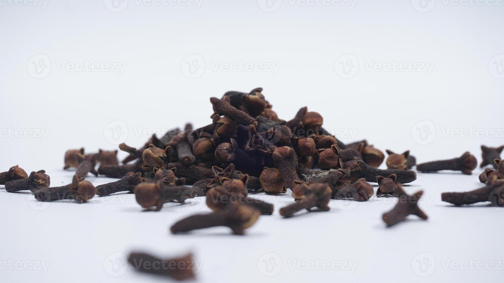 Scattered Cloves with Selective Focus Isolated on White Background photo
