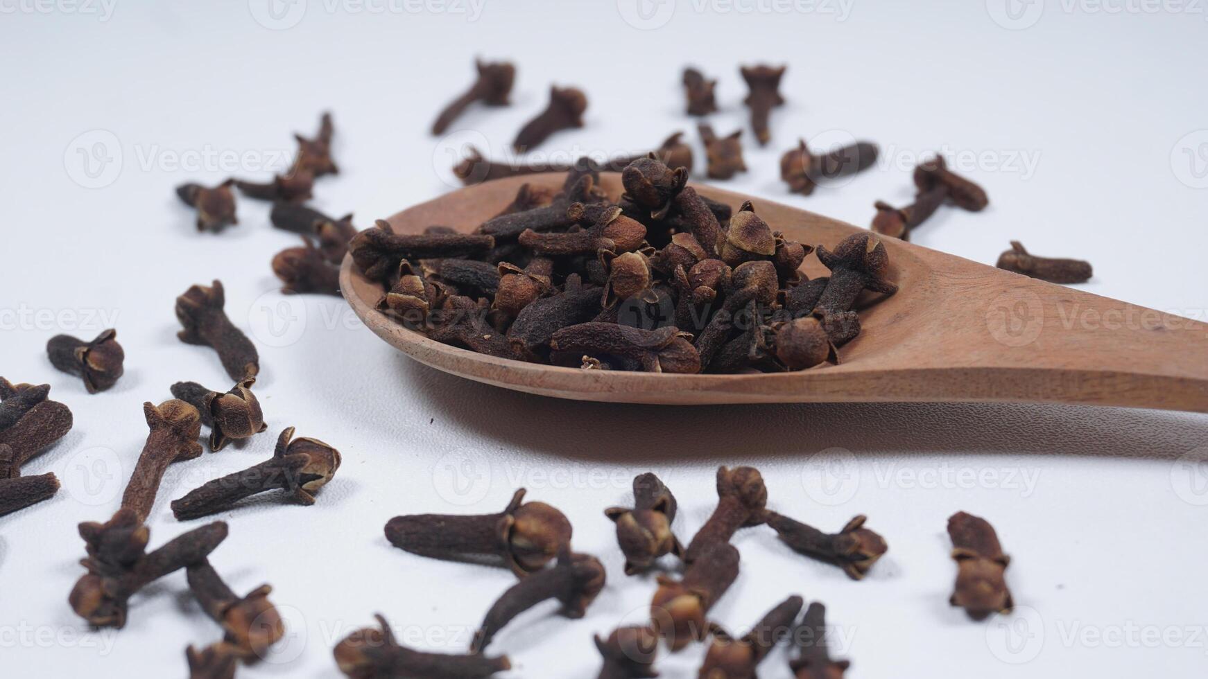 Cloves Spice on Wooden Spoon Isolated on White Background photo