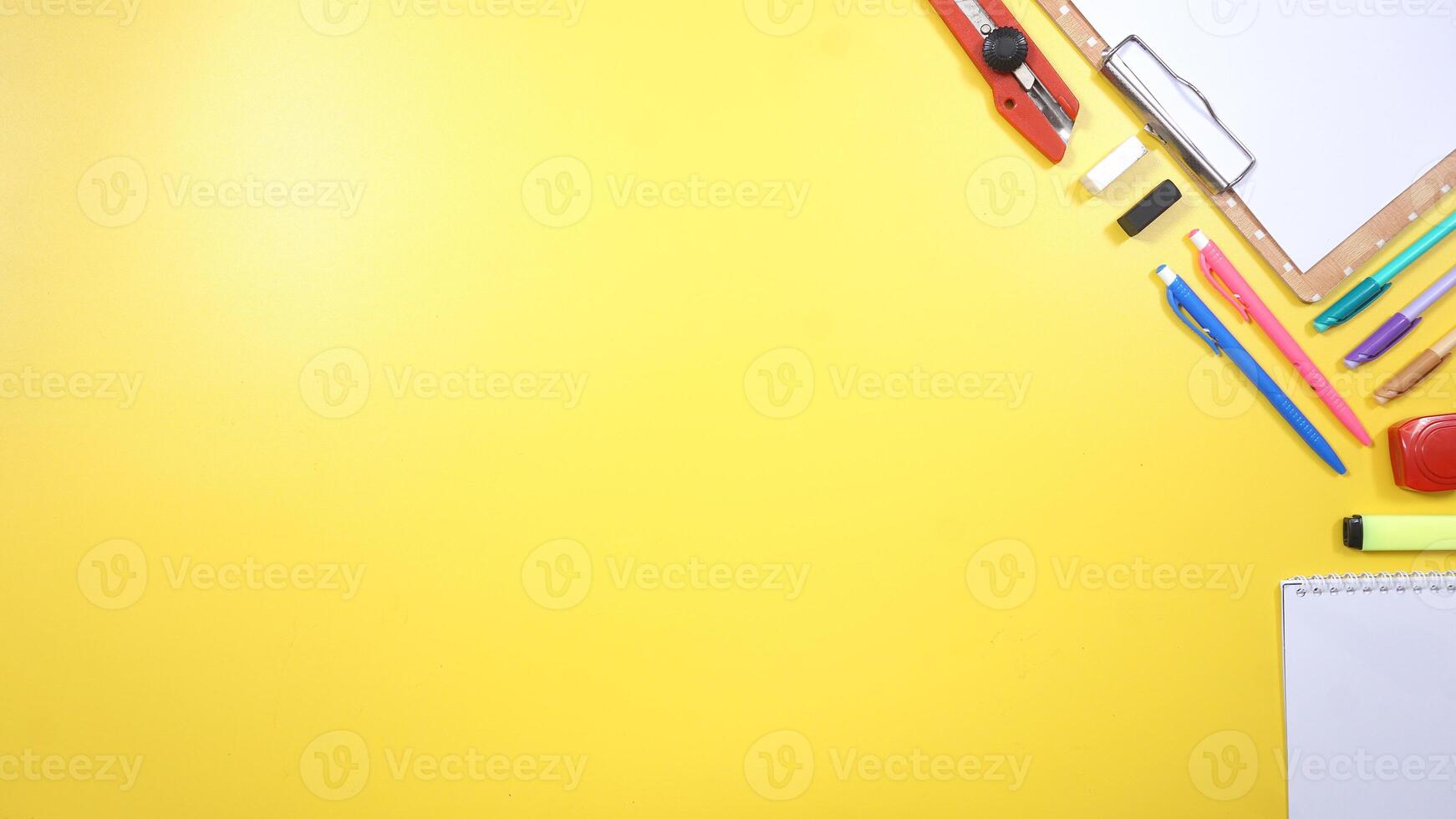 School Stationery, Notebook, and Wooden Clip Board with Copy Space on Yellow Background photo