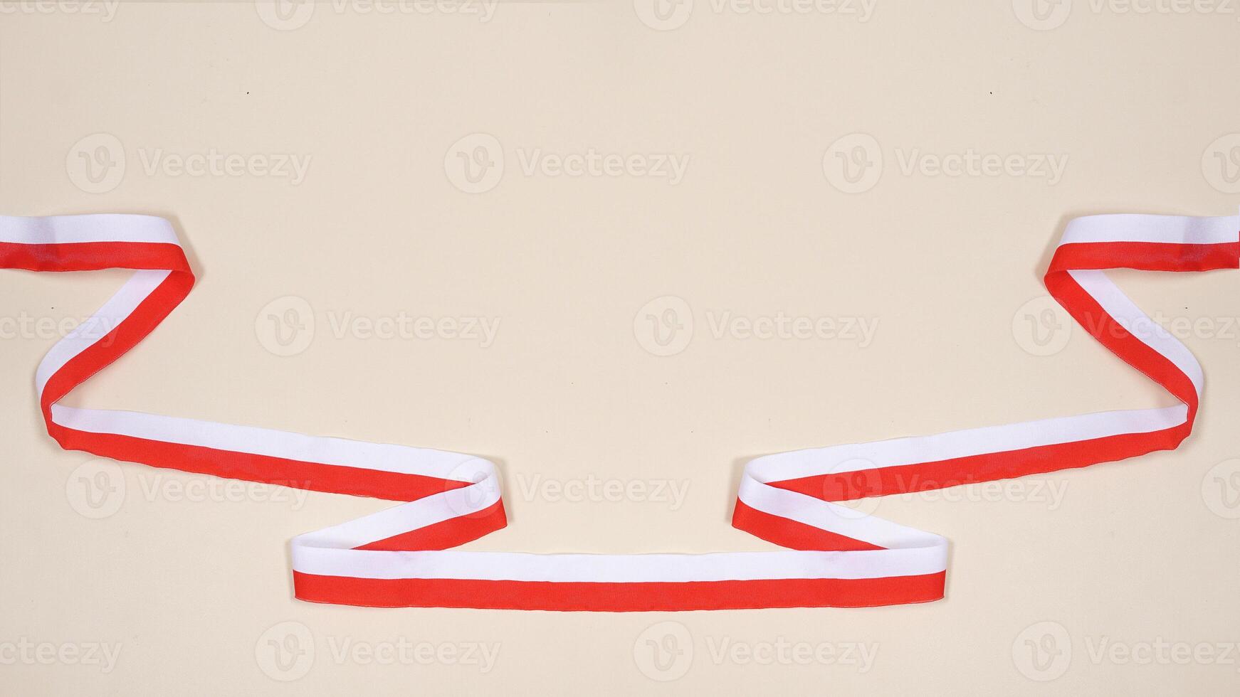 Red and White Ribbons as Symbol of Indonesia National Flag with Copy Space Area on Light Background photo
