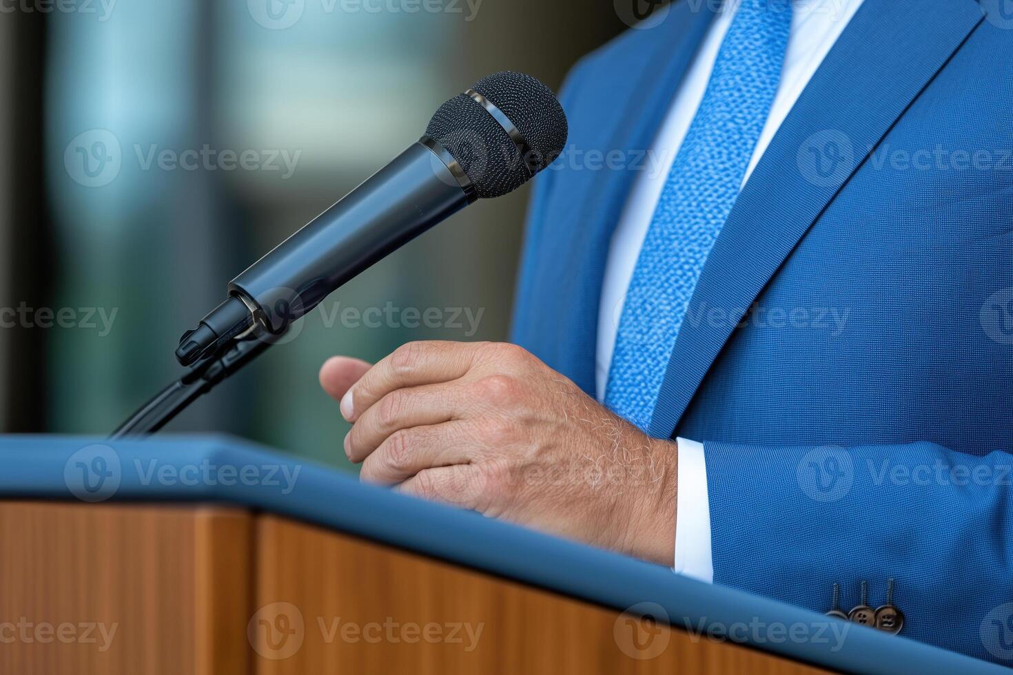 close up of speaker's hand giving speech at podium photo
