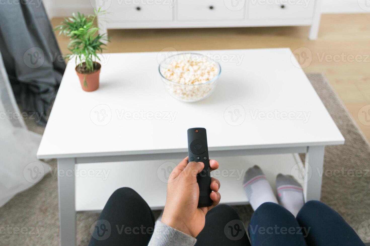 Remote control is pointed toward the television screen, control and choice of tv entertainment. TV, series and streaming service concept photo
