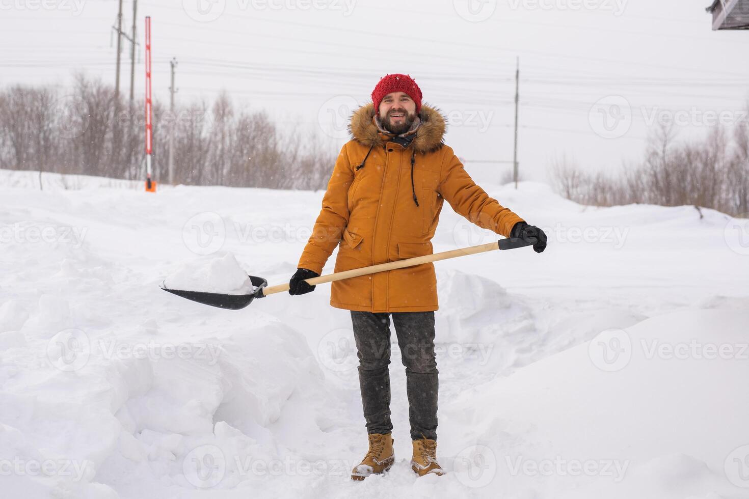 Man cleaning snow from sidewalk and using snow shovel. Winter season photo