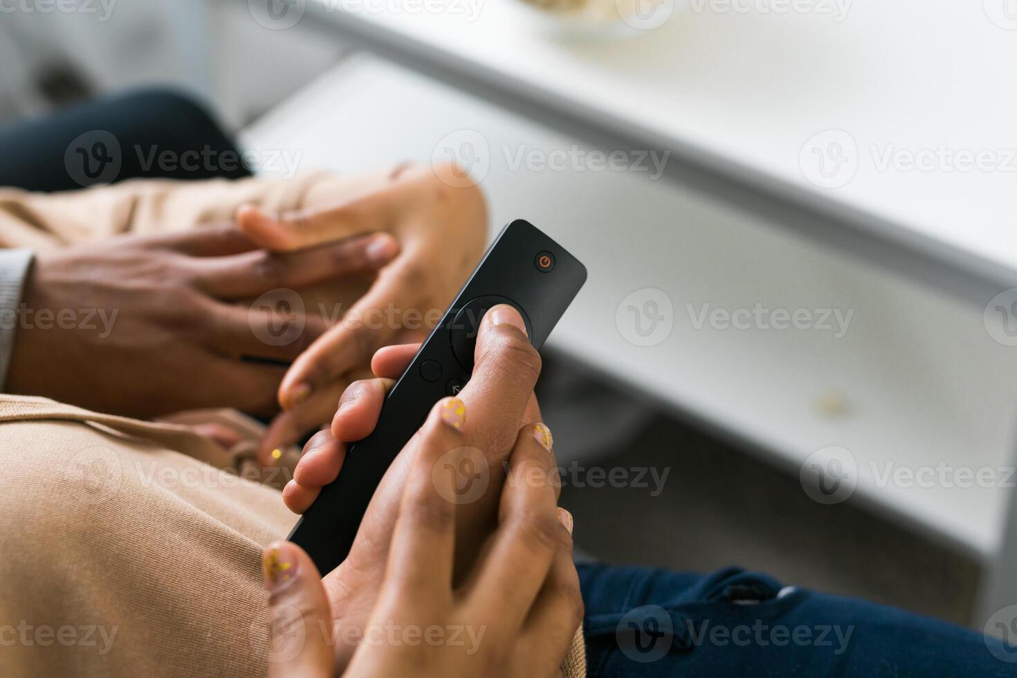 Remote control is pointed toward the television screen, control and choice of tv entertainment. TV, series and streaming service concept photo