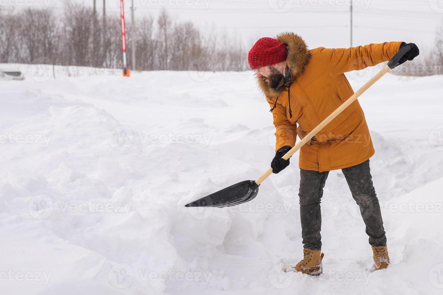 Man cleaning snow from sidewalk and using snow shovel. Winter season photo