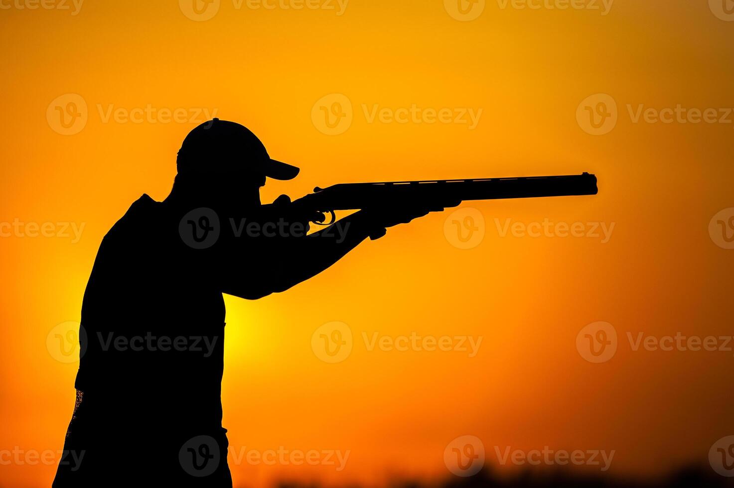 A man is silhouetted in front of a sunset photo