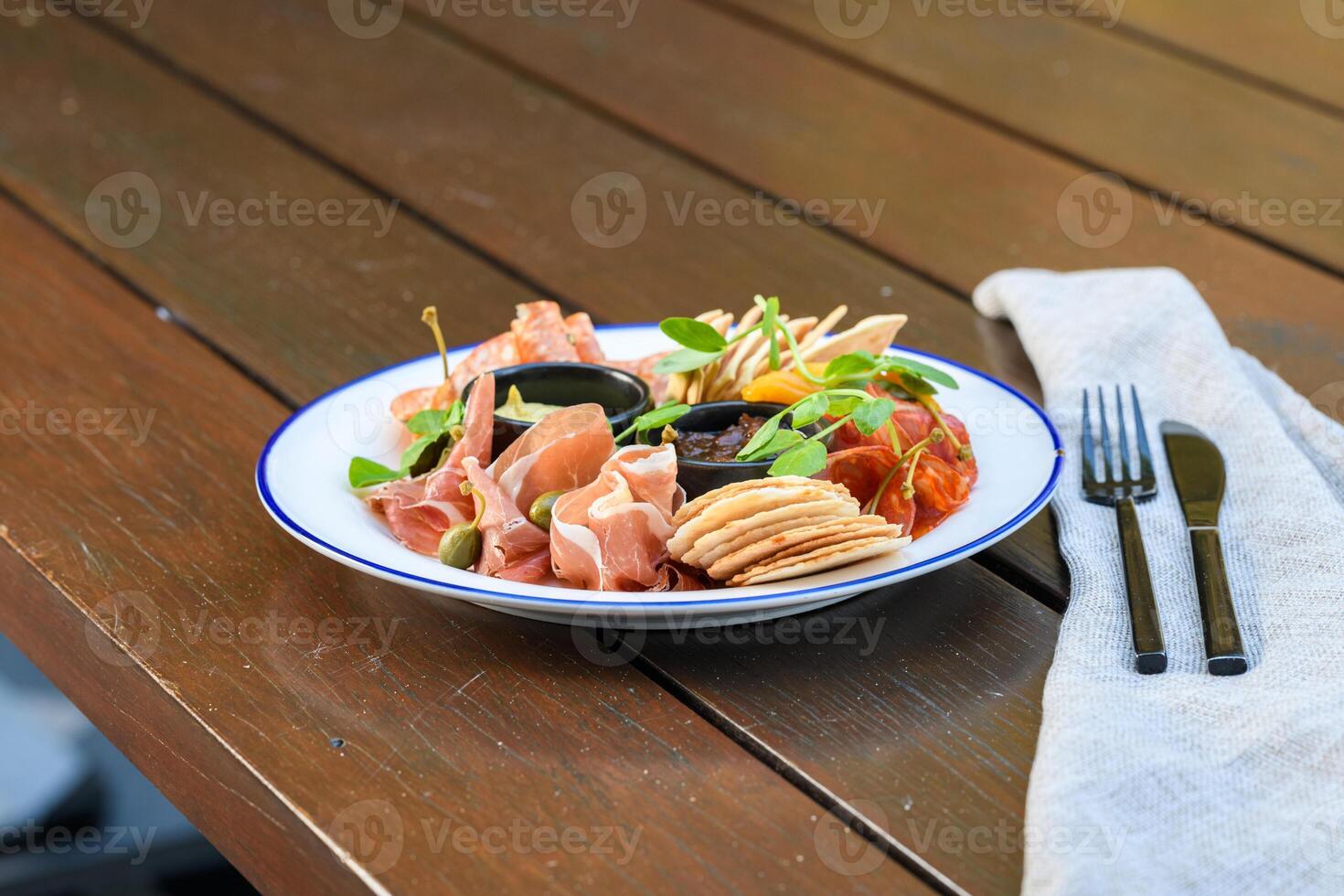 A plate of food on a table with a napkin photo
