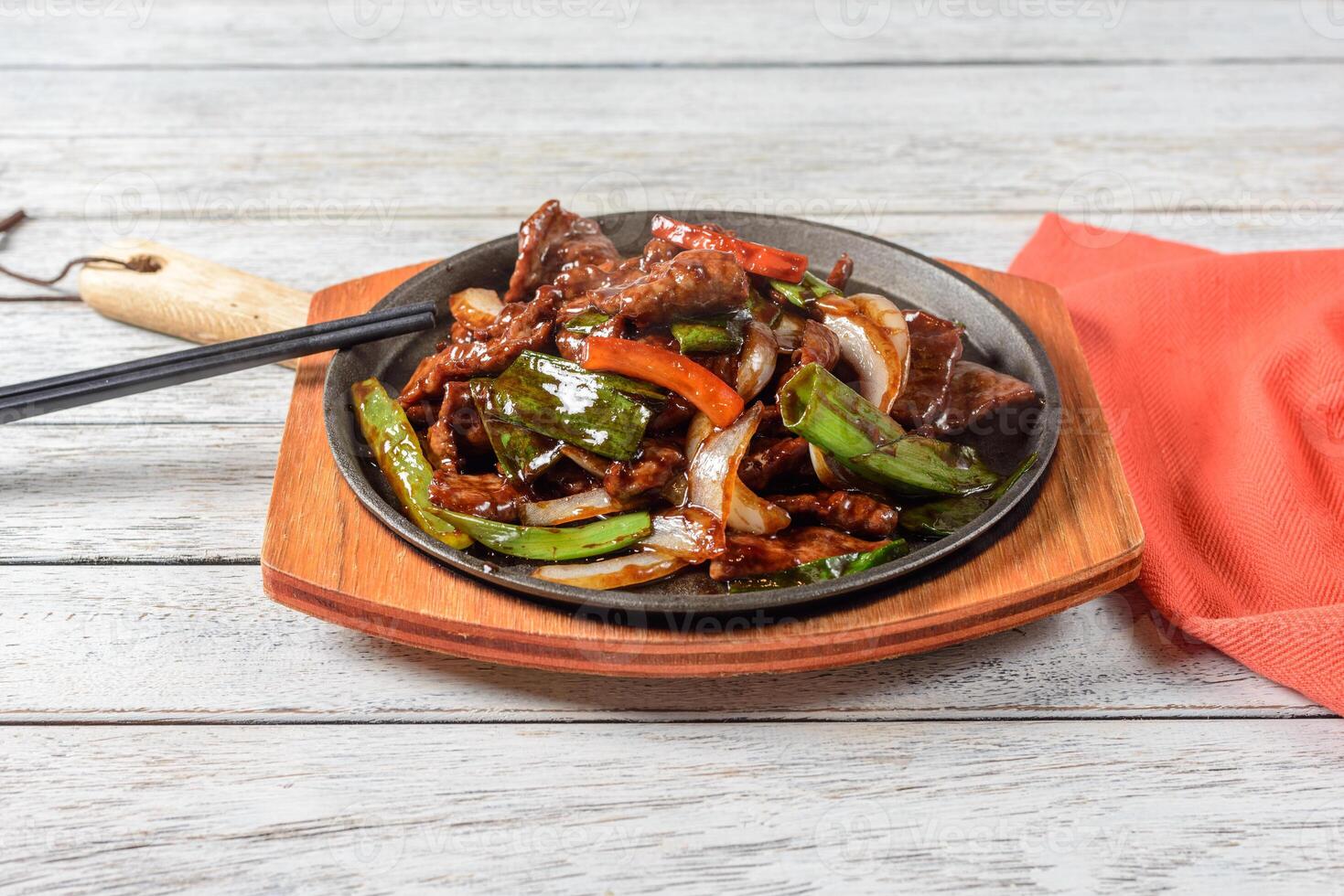 A plate of food with chopsticks and a napkin photo