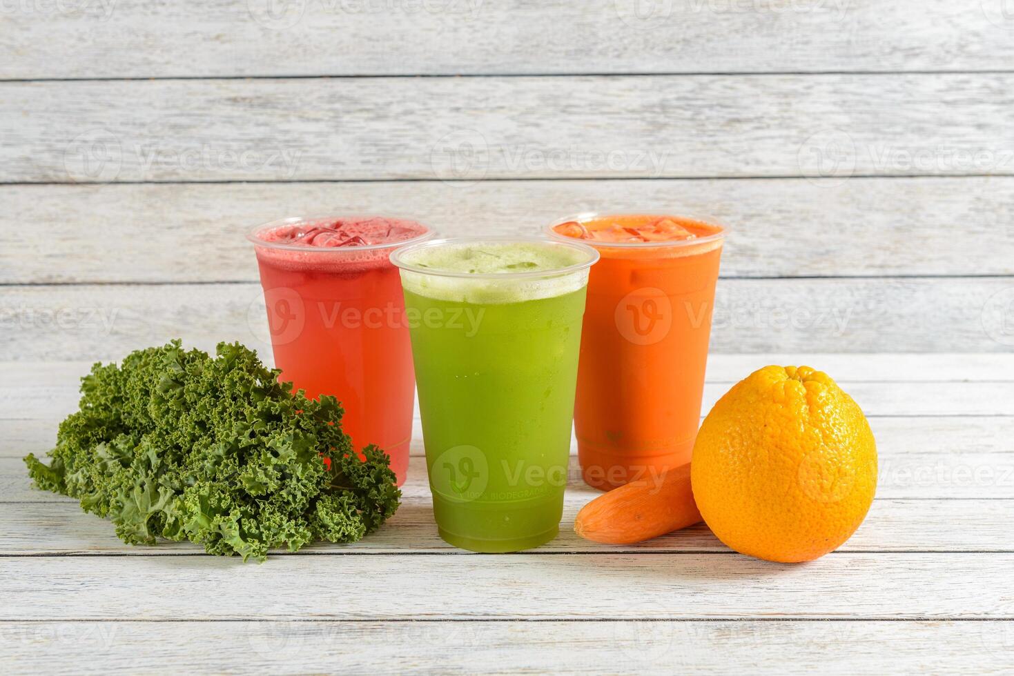 A group of juice drinks and an orange on a table photo
