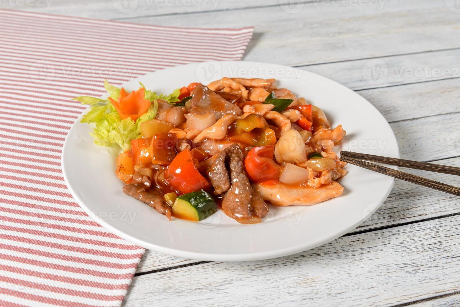 A plate of food with chopsticks on a table photo