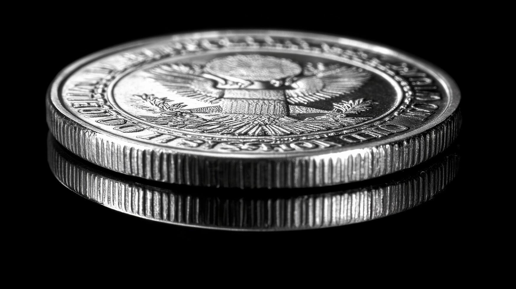 Detailed close-up of a silver coin showing a historic figure against a dark background photo