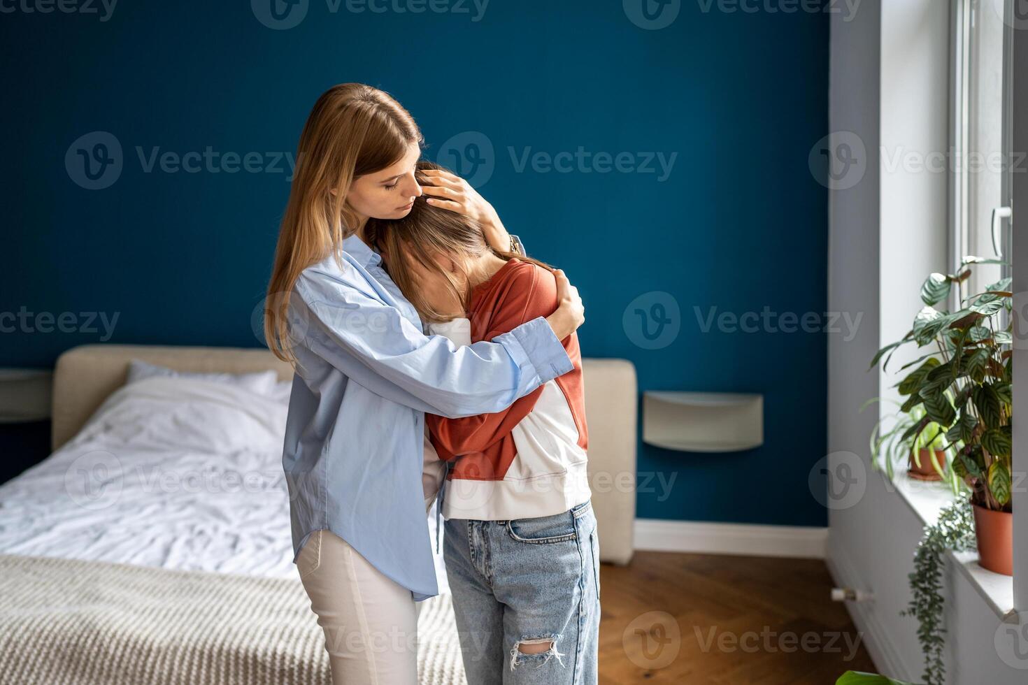Crying upset teen girl child sharing feelings with mother, loving supportive mom hugging daughter photo