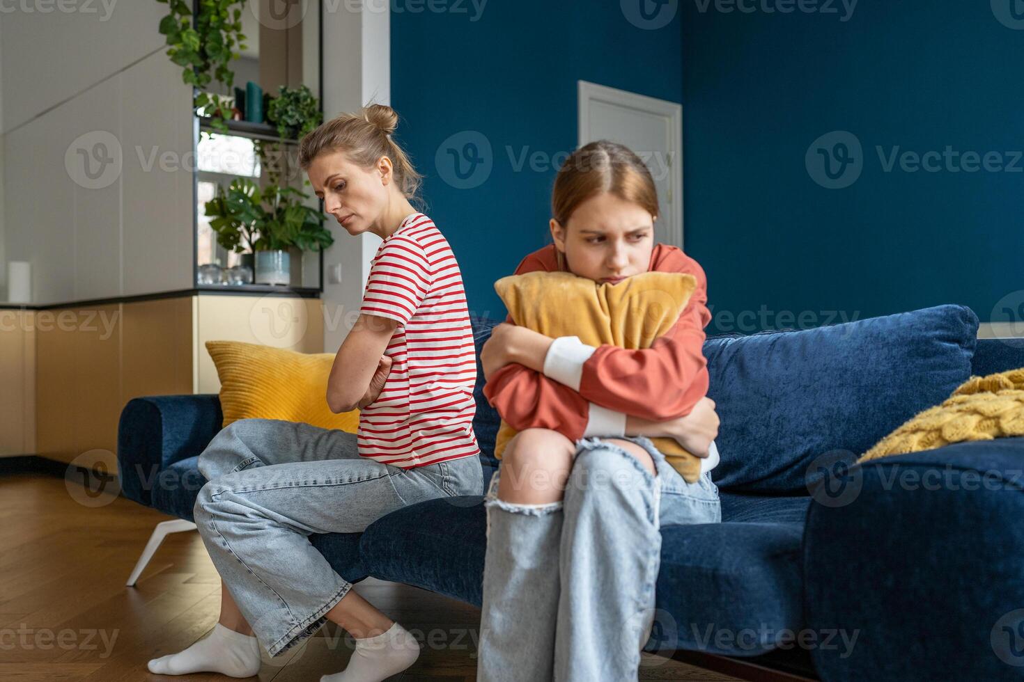 Upset frustrated mother and teenage daughter ignoring each other after quarrel at home, not talking photo