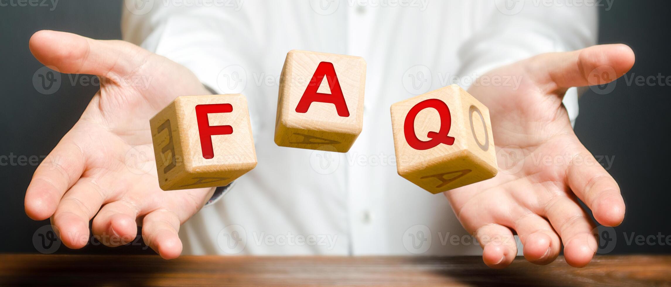 Cubes thrown by a man make word abbreviation acronym FAQ frequently asked questions Instructions and rules. Avoid frequent errors. photo