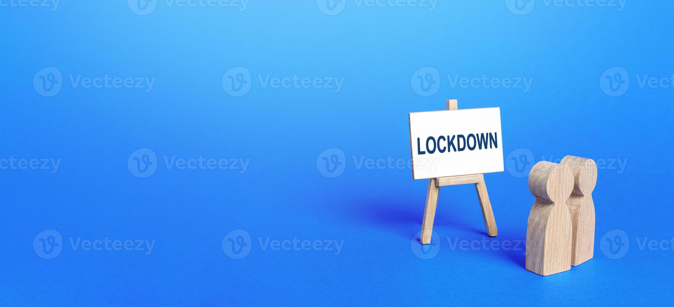 Figures of houses and an easel with the word Lockdown. photo