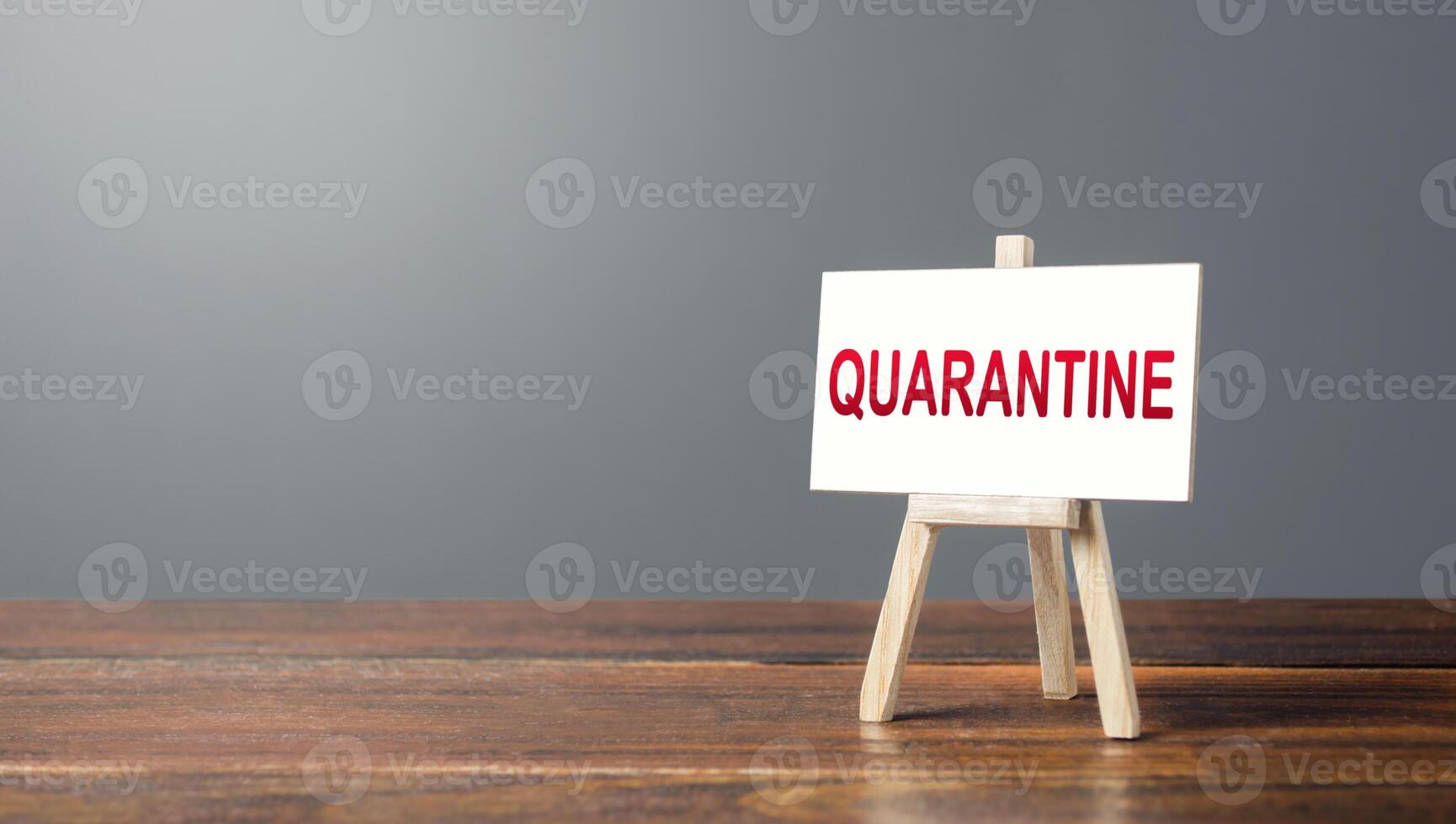 Easel with a word Quarantine. Tough measures to stop new infections of coronavirus COVID-19 exponential growth. Self-isolation during pandemic. Administrative restrictions at contagion epicenters photo