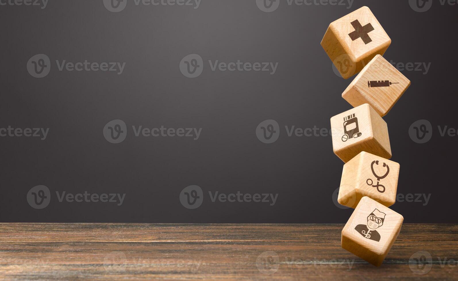 Tower of blocks with medical attributes icons. Provision of medical services supplies in pandemic. Dispatch of humanitarian aid, specialists to stop coronavirus COVID-19 spreading. First aid equipment photo