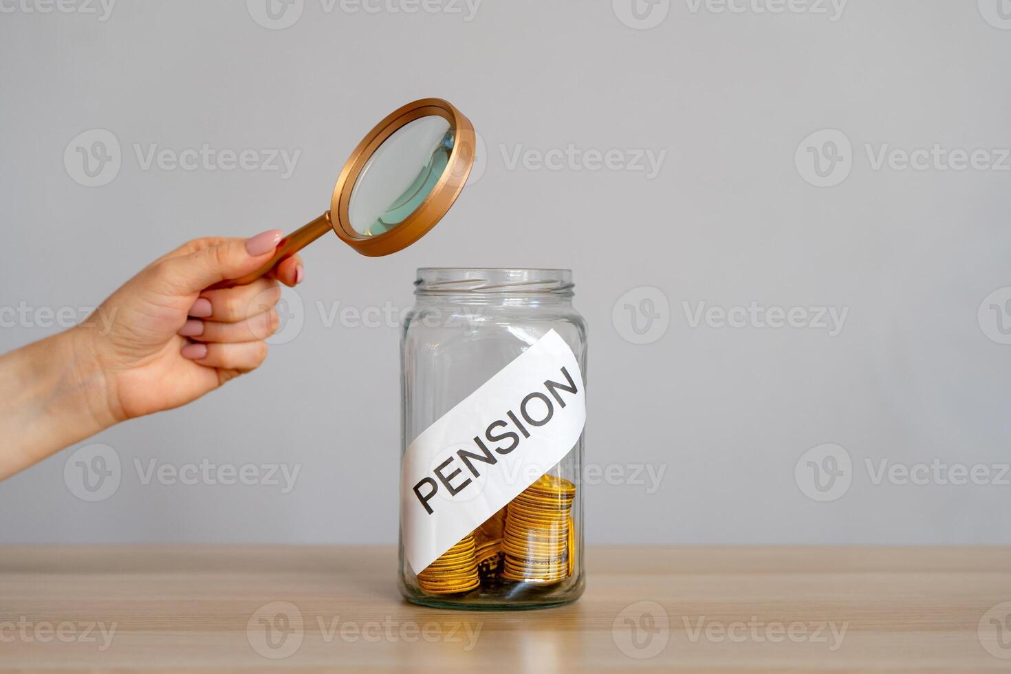 Bank of coins and the inscription Pension. Saving money and retirement concept photo
