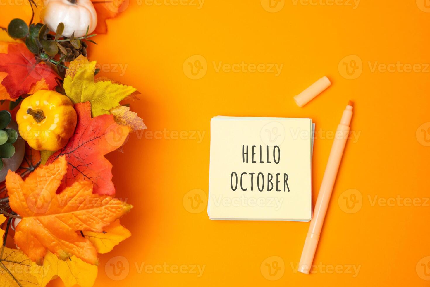 Notes with words Hello october and fall leaves. Concept of beginning of autumn and new season photo