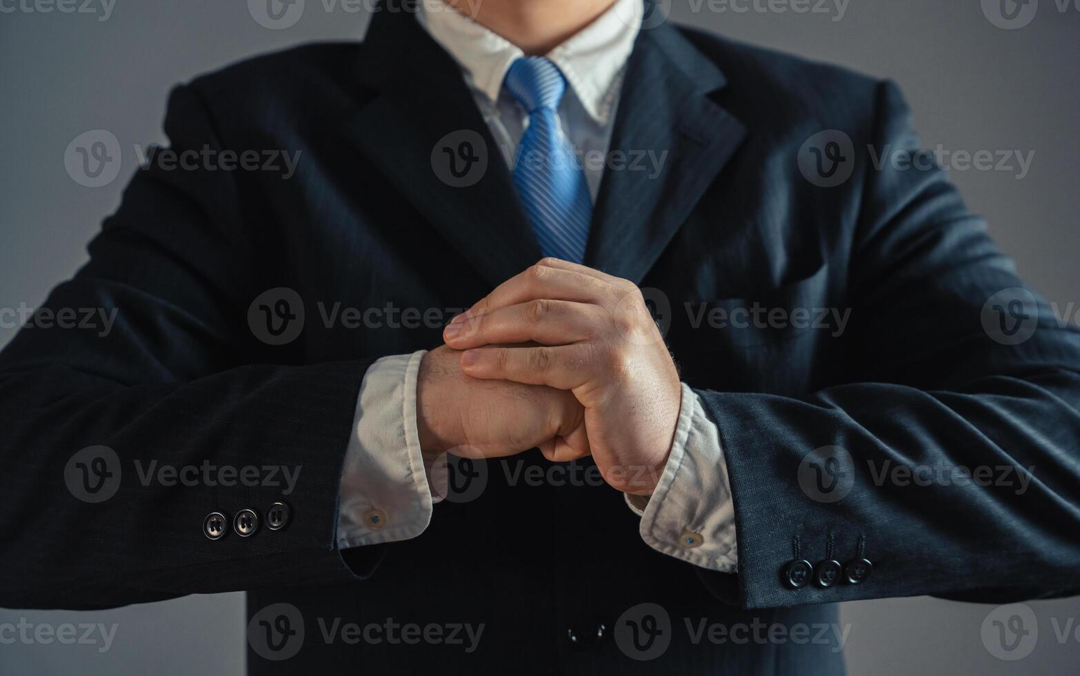 Businessman flexing his fists. Concept of readiness to take on something serious. Accepting a challenge. Competition and rivalry. Full dedication to work. Overcome challenges. photo