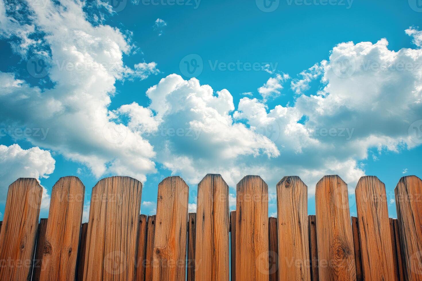 Wooden fence rising to a beautiful cloudy sky.. photo
