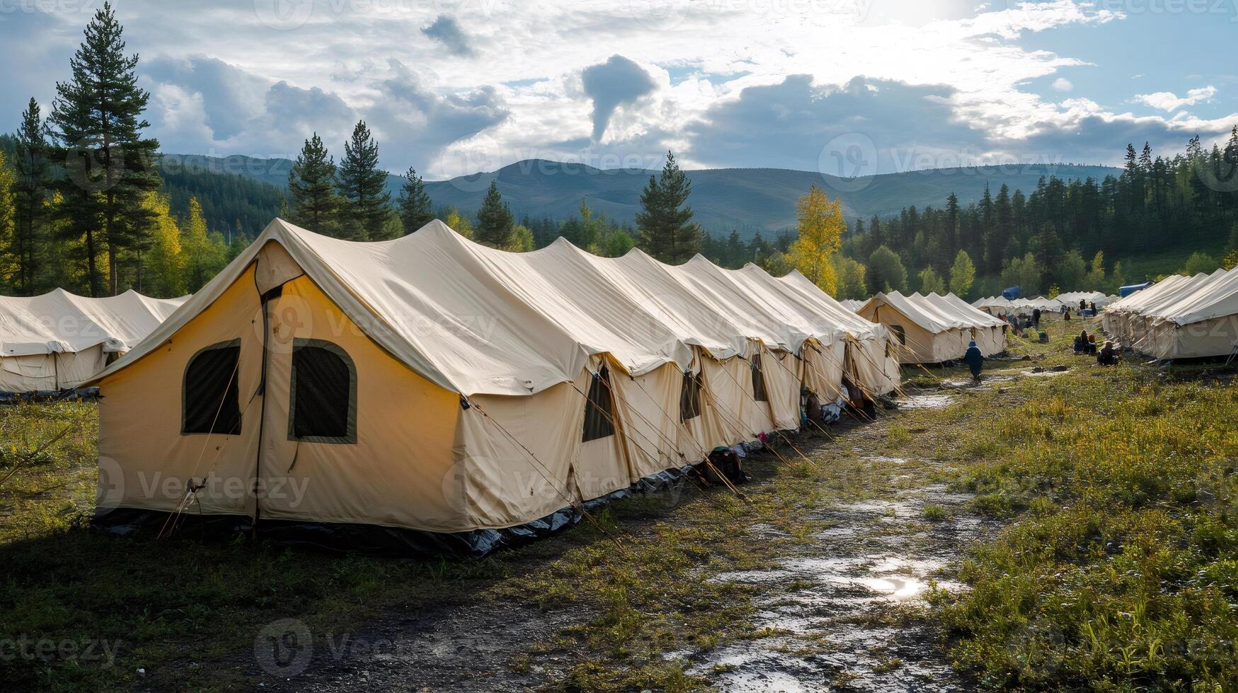 Camping tent village setting up in wilderness mountain valley photo
