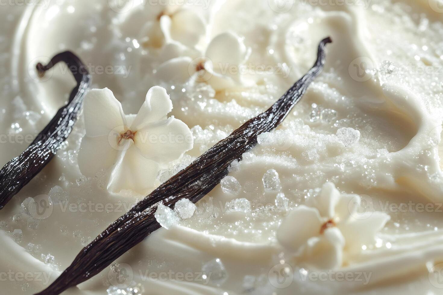 Vanilla pods, flowers and sugar crystals resting on creamy white surface photo