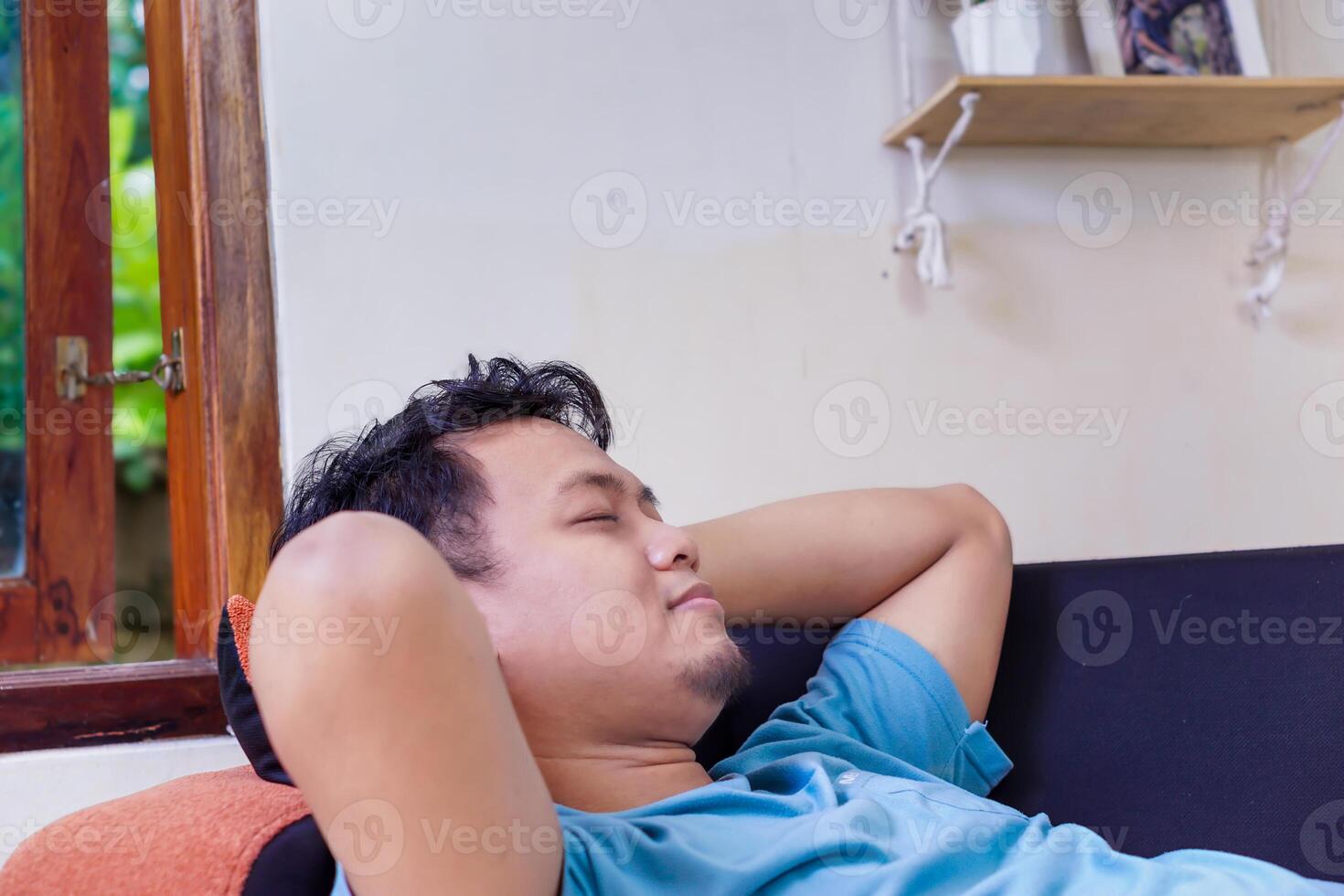 a man laying on a couch photo