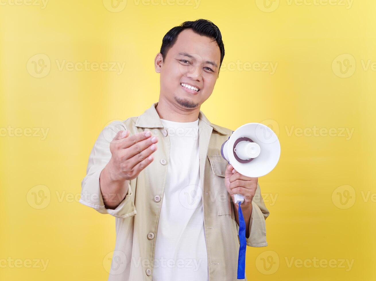 a man holding a megaphone on a yellow background photo
