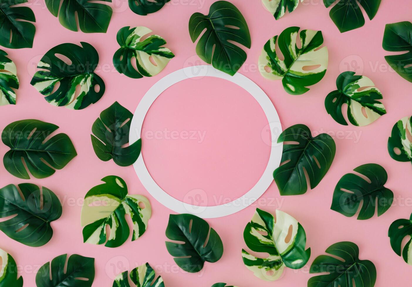 Trendy summer pattern made of green tropical leaves with copy space on light pink background. Minimal creative concept. Exotic backdrop flat lay image. Summer aesthetic. photo